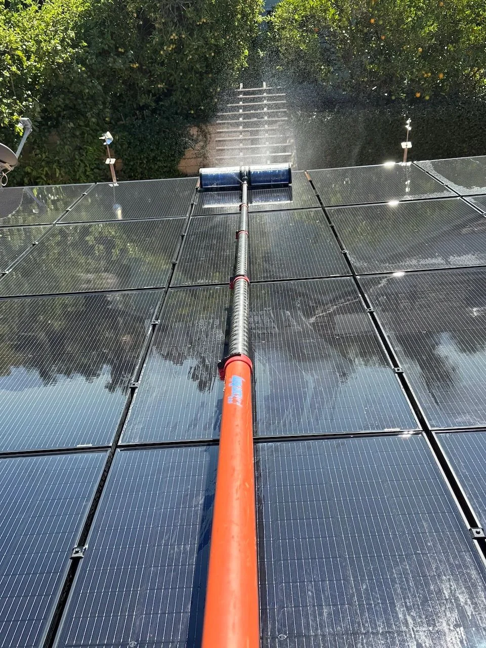 Cleaning brush across solar panels — original business project photo